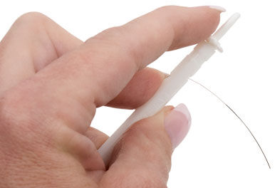 Hand holding wire against anchor hole on rod